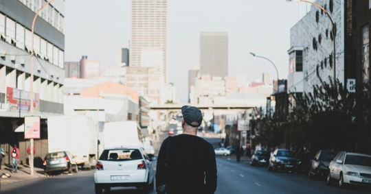 man walking the street on his own